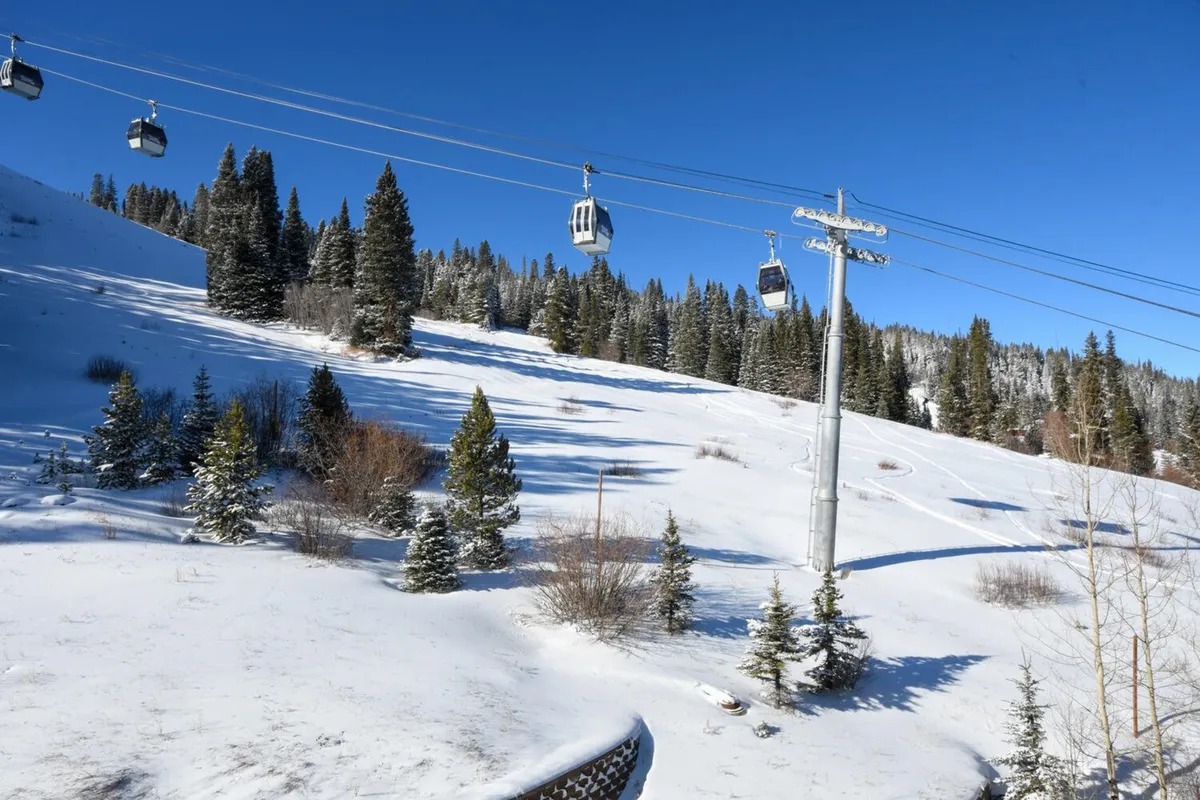 A wintry exterior landscape showcasing ski lifts, snow-covered hills, and pine trees. The mood is adventurous, with hints of winter activities such as skiing, snow tubing, and snowboarding.
